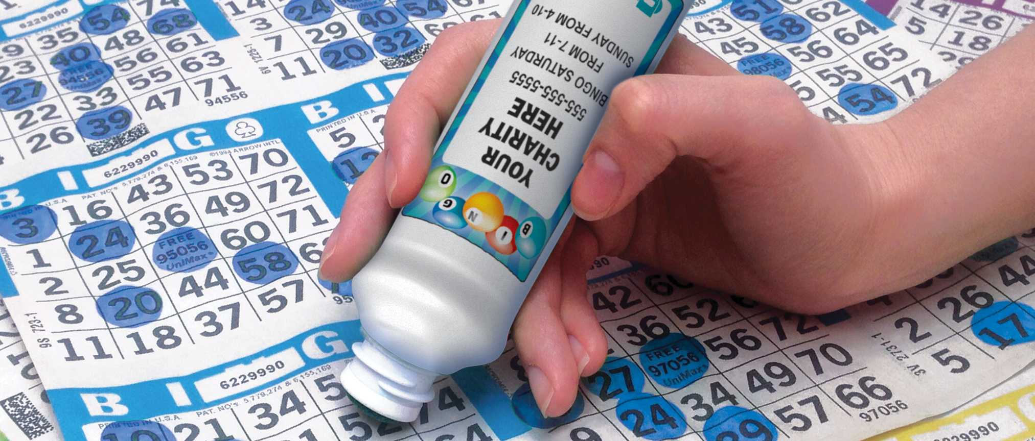 woman marking bingo paper with a bingo dauber